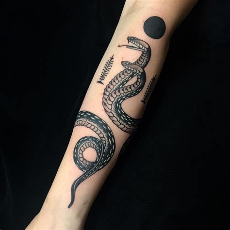 snake wrap around arm tattoo